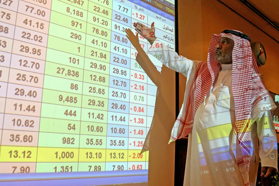 Screen time: a man inspects stock prices at a bank in Riyadh, Saudi Arabia on Saturday