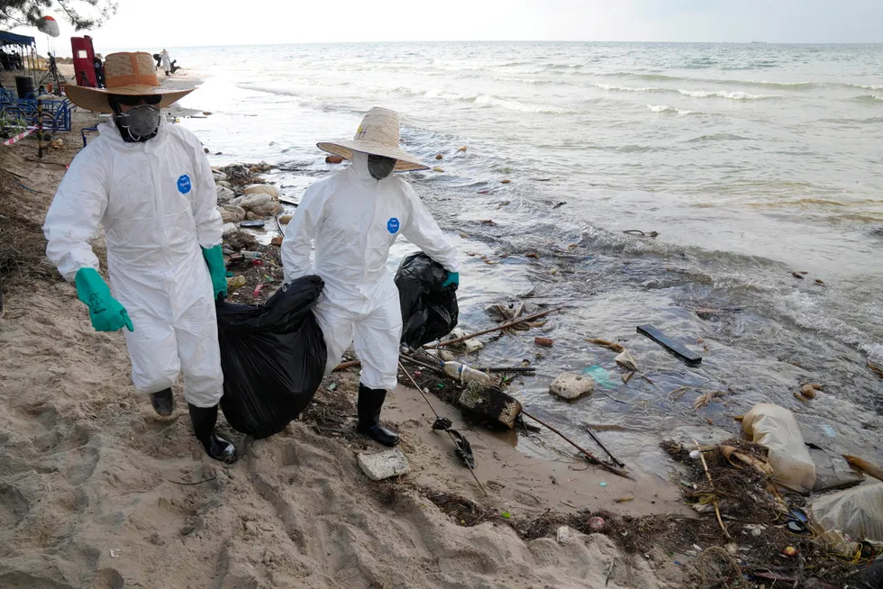 Clean-up: workers on Mae Ramphueng beach after the pipeline oil spill off the coast of Rayong province in eastern Thailand