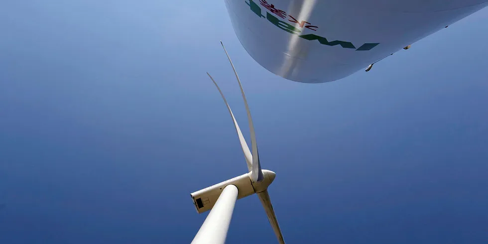 A wind turbine and a hydrogen storage tank in Japan. Offshore wind is seen as a key enabler of green hydrogen production.