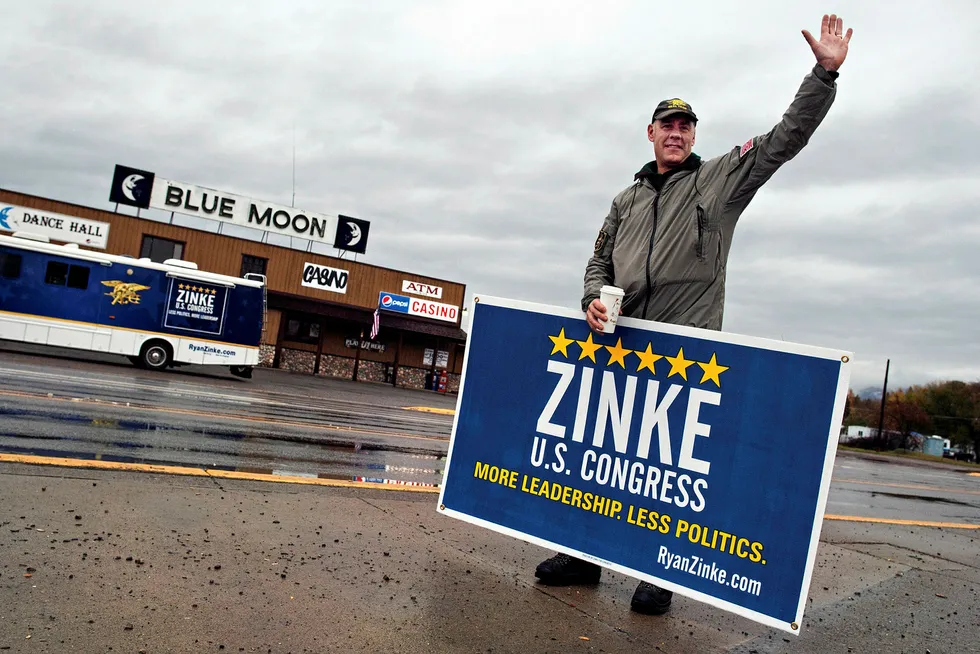 FILE - In this Nov. 4, 2014, file photo, Republican U.S. House candidate Ryan Zinke waves to supporters in Columbia Falls, Mont. The campaign's recreational vehicle, shown in the background, was recently sold to a Montana legislator up for a key post in the U.S. Interior Department, now headed by Zinke. The transaction is prompting questions about the appropriateness of the sale because of the $25,000 selling price, which is about half of the typical selling price for a similar motorhome in good condition. (Greg Lindstrom/Flathead Beacon via AP, File)