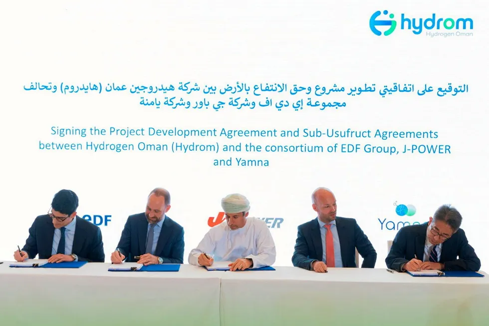 The award signing ceremony for the EDF, J-Power and Yamna consortium, with Omani energy minister Salim Al Aufi in the centre.