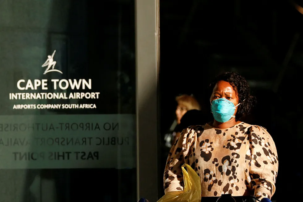 Bans: a traveller wearing a face mask as a protection against the coronavirus disease (Covid-19), leaves the Cape Town International Airport, in Cape Town, South Africa
