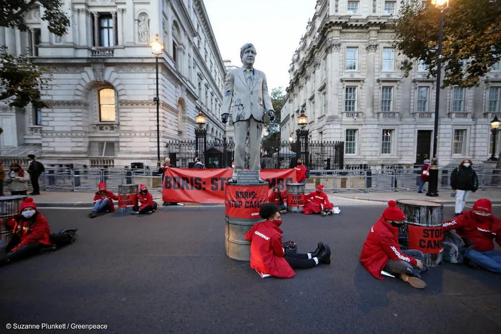 Protest: Greenpeace activists block the entrance to Downing Street with a four-metre statue of UK Prime Minister Boris Johnson