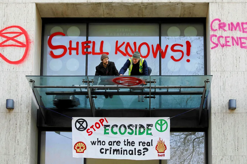 Message: activists spray graffiti at the entrance to the Shell Centre in London