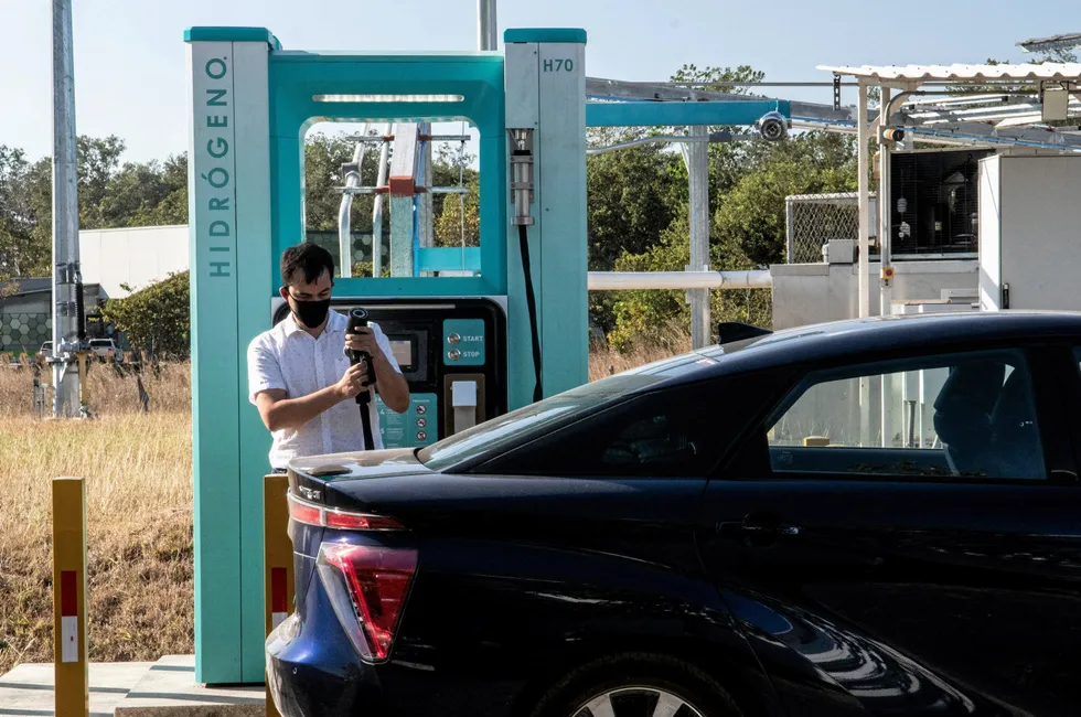 A man filling his Toyota Mirai hydrogen car at a refuelling station in Costa Rica.
