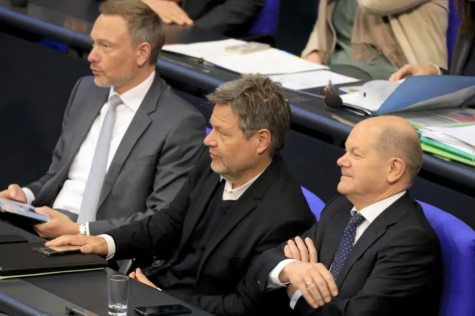 German Chancellor Olaf Scholz, right, in the Bundestag with the leaders of his coalition partners, the Greens' Robert Habeck, centre, and FDP head Christian Lindner.