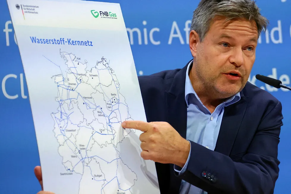 German Economy and Climate Minister Robert Habeck points at a map showing Germany's hydrogen network during a press conference in Berlin