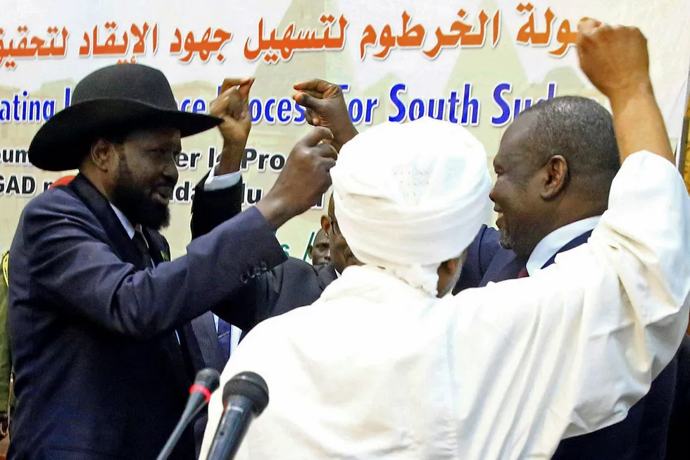 Embrace: South Sudan President Salva Kiir (left) and rebel leader Riek Machar (right) dance during a South Sudan peace meeting last Friday
