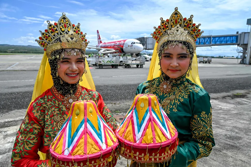 Welcoming: traditional dancers pose next to a plane after Covid-19 restrictions on travel by plane from Malaysia to Aceh were lifted.