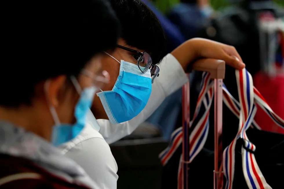 Virus fears weigh on prices: passengers wear masks to prevent an outbreak of a new coronavirus at the Hong Kong West Kowloon High Speed Train Station