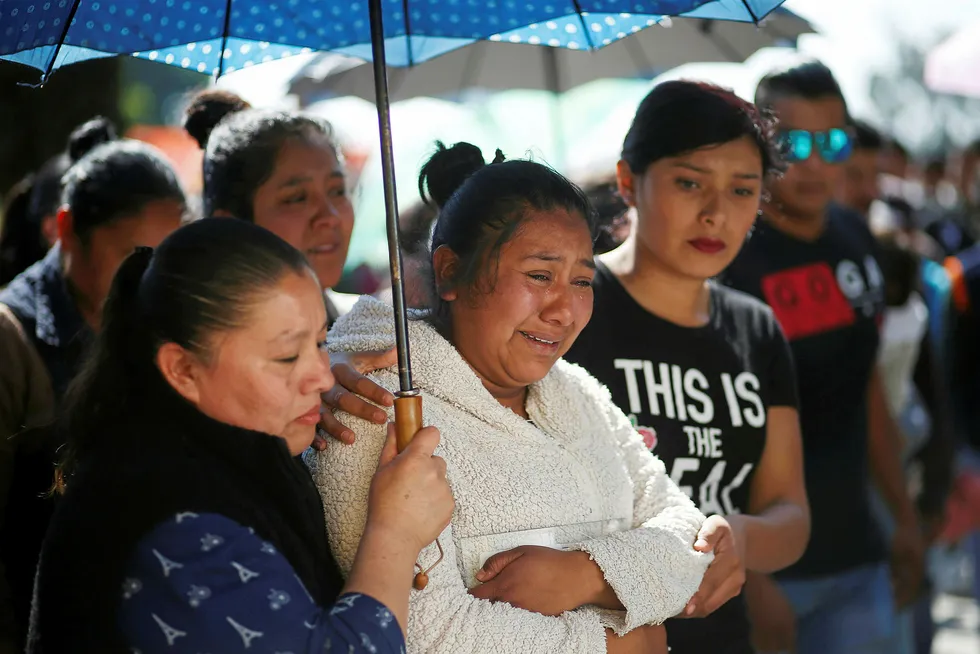 Aftermath: residents react after a mass for a relative who died during the explosion of the fuel pipeline in Mexico