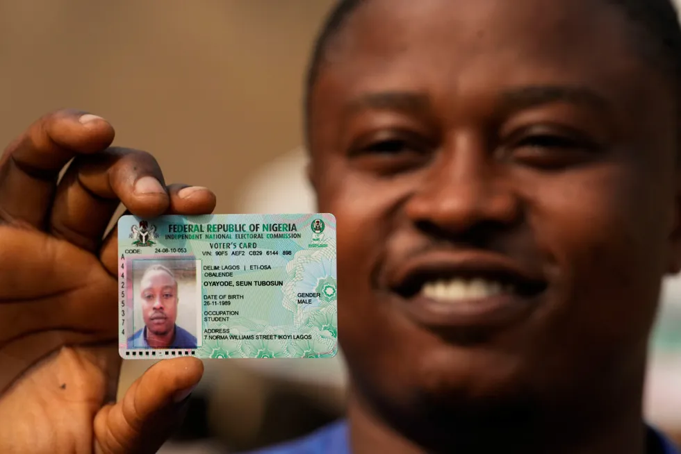Ready to decide: a youth shows his permanent voter card ahead of presidential elections on 25 February.