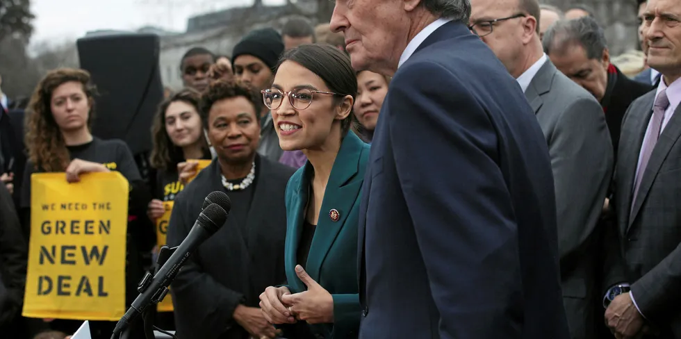 Alexandria Ocasio-Cortez (D-NY) speaks as Sen. Ed Markey (D-MA) and other Congressional Democrats listen during a news conference in front of the U.S. Capitol in Washington, DC.