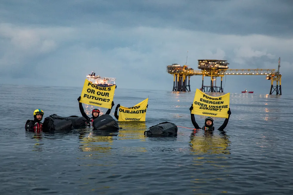 Turmoil: Greenpeace activists in Denmark last year. A new poll indicates an oil and gas industry recovery will include more spending on low-carbon and renewable energy