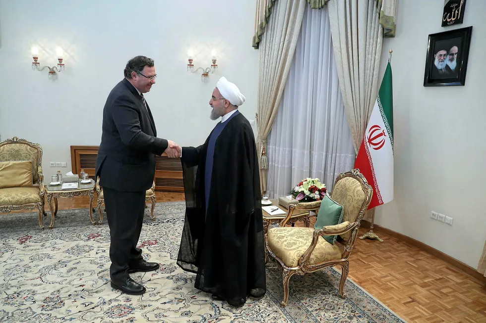 Flashback: Total chief executive Patrick Pouyanne (left) shakes hands with Iranian President Hassan Rouhani after signing an agreement in Tehran last year. Total has now officially quit the South Pars 11 project