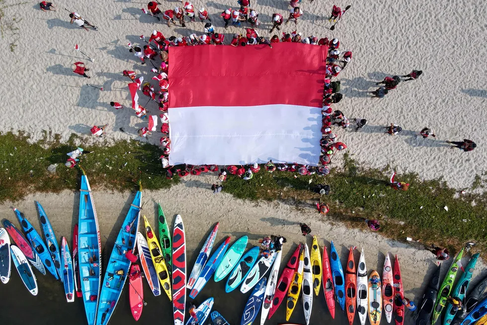 Patriotic: recreational kayakers unfurl the Indonesian national flag as part of the nation's Independence Day celebrations.