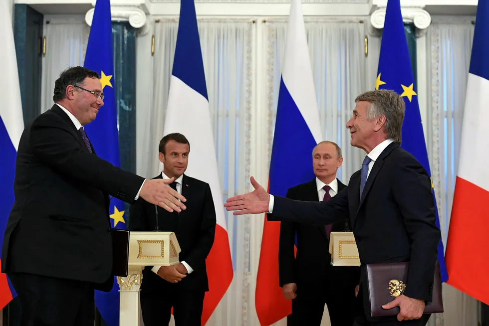 Centre stage: Total chief executive Patrick Pouyanne (left) exchanges documents with Novatek chief executive Leonid Mikhelson (right) as French President Emmanuel Macron and Russian President Vladimir Putin Look on during the signing ceremony at St Petersburg