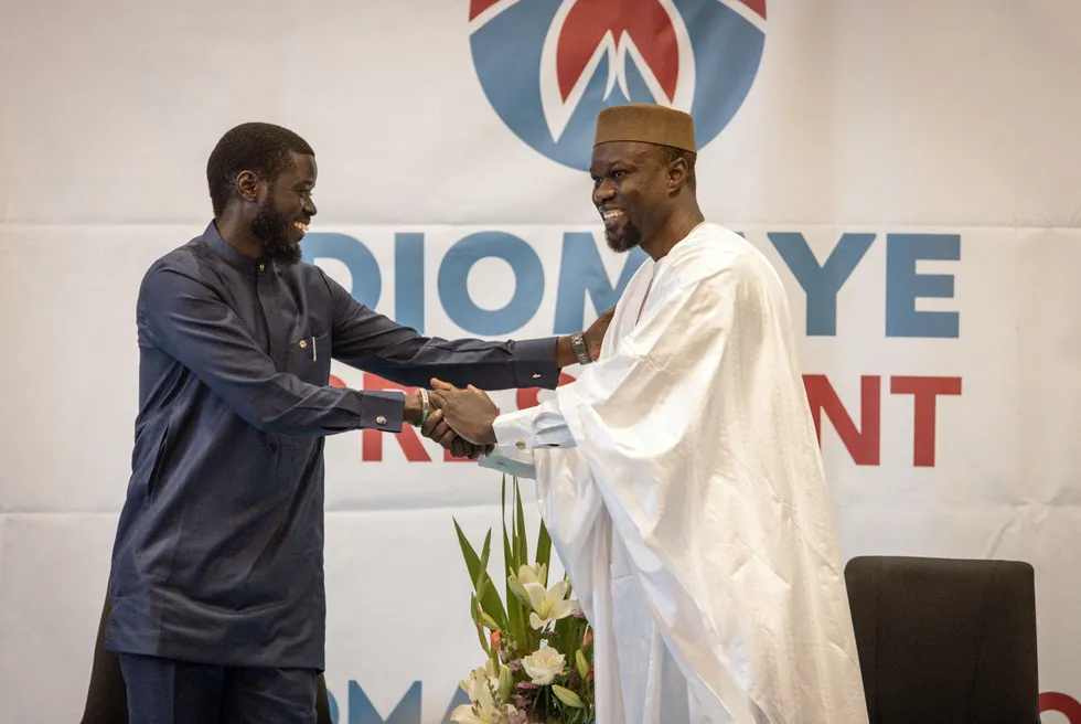 Opposition leader Ousmane Sonko (right) greets presidential candidate Bassirou Diomaye Faye (left) during a press conference in Dakar, Senegal on 15 March.