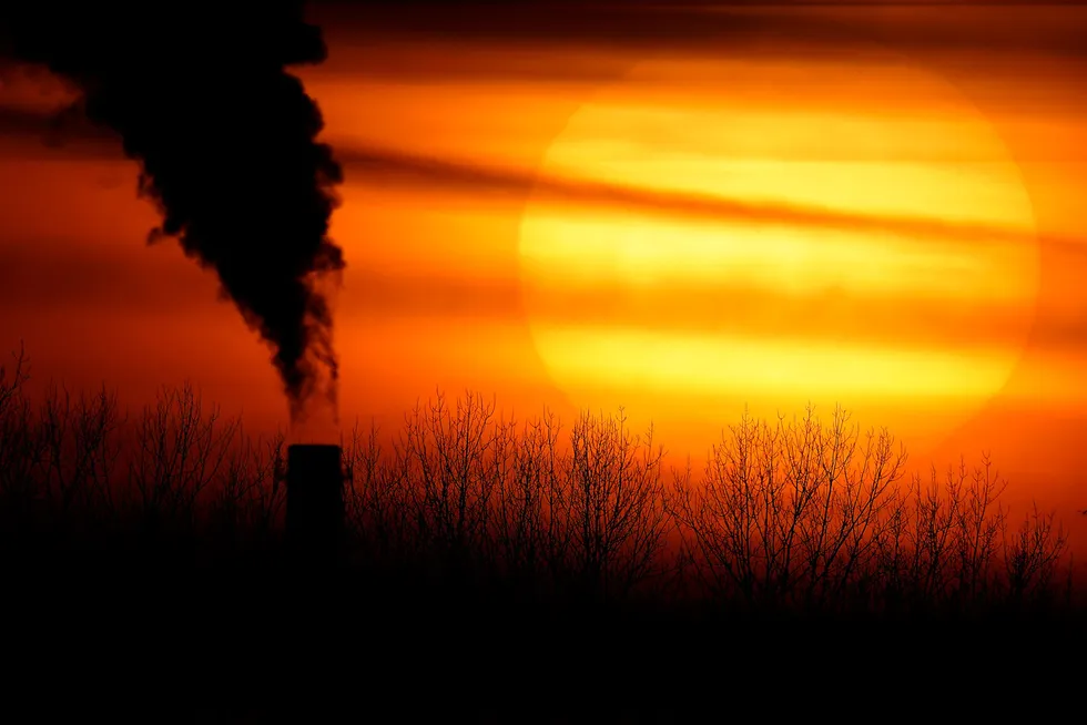 Net zero goals: emissions from a coal-fired power plant are silhouetted against the setting sun in Independence, Missouri, US