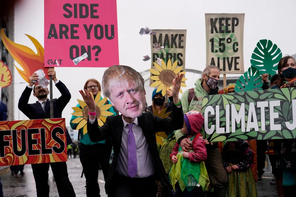 Not the real Boris: a climate activist wearing a mask of British Prime Minister Boris Johnson takes part in a demonstration against the use of fossil fuels outside the venue for the COP26 UN Climate Summit in Glasgow on 12 November