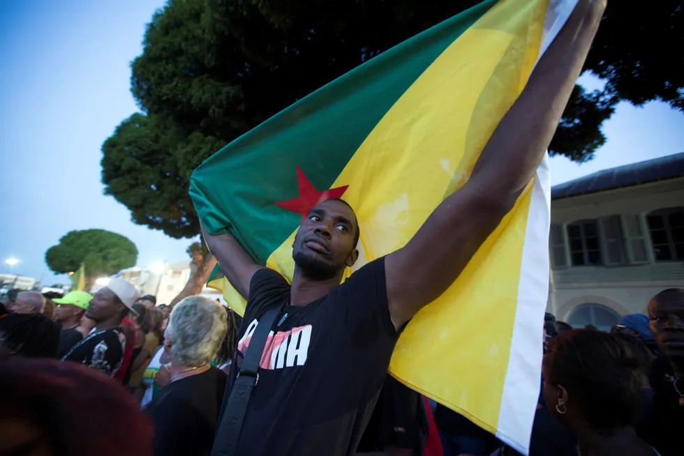 Proud: a man holds the Guyana flag