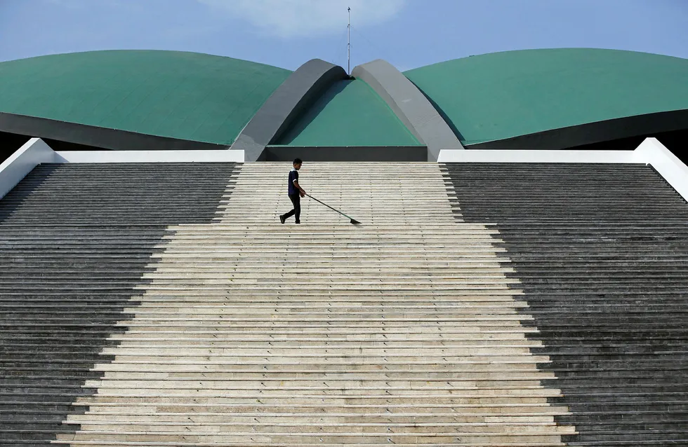 Decision expected: a worker cleans the stairs leading to the parliament building in Jakarta, Indonesia