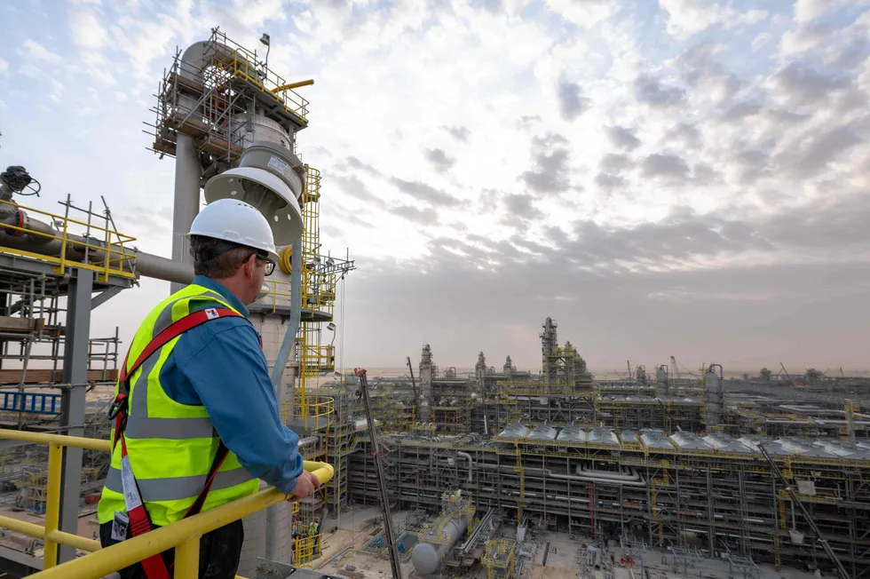 Taking the long view: A worker looks over a Saudi Aramco facility. The Saudi company has decided to pause its plans for a major production capacity expansion.
