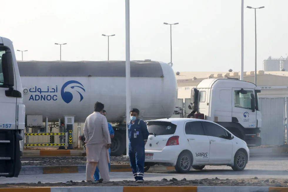 Fresh escalation: men stand outside an Adnoc storage facility in Abu Dhabi