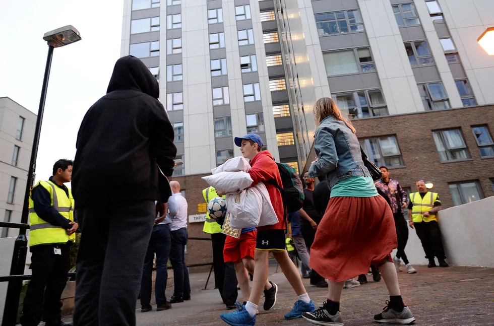 Beboere forlater en blokk i bydelen Camden i London. Flere blokker ble evakuert da man fant samme fasademateriale som ble brukt i Grenfell Tower, der en katastrofal brann nylig kostet mange liv. Foto: Stefan Rousseau