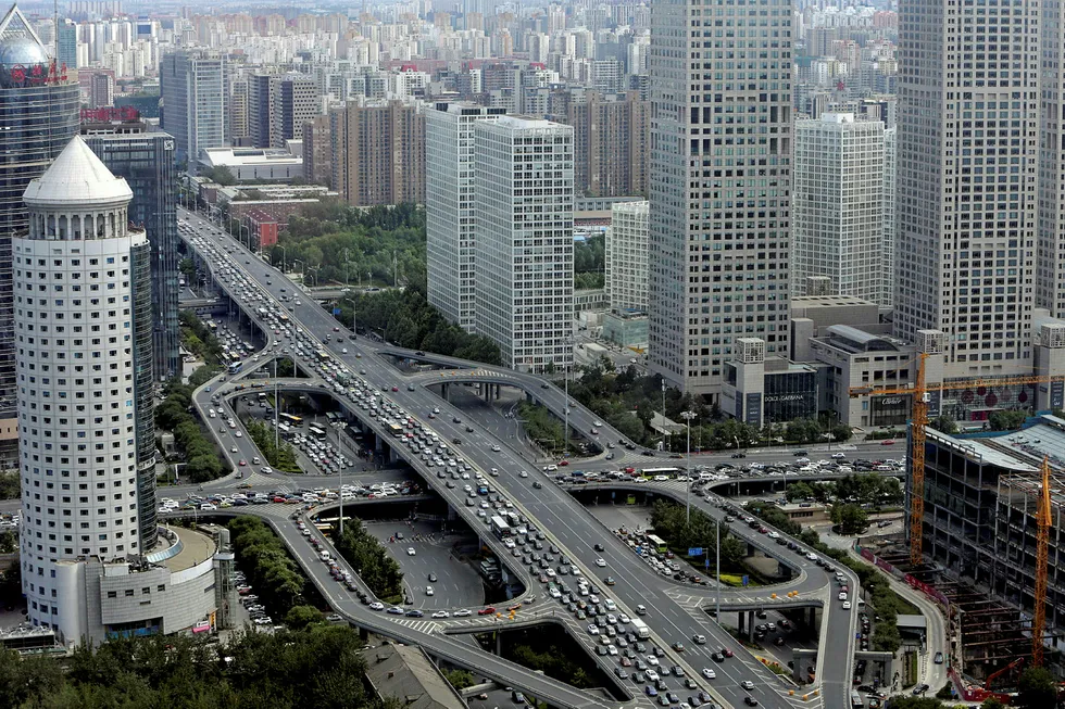 Vehicles drive on the Guomao Bridge through Beijing's central business district