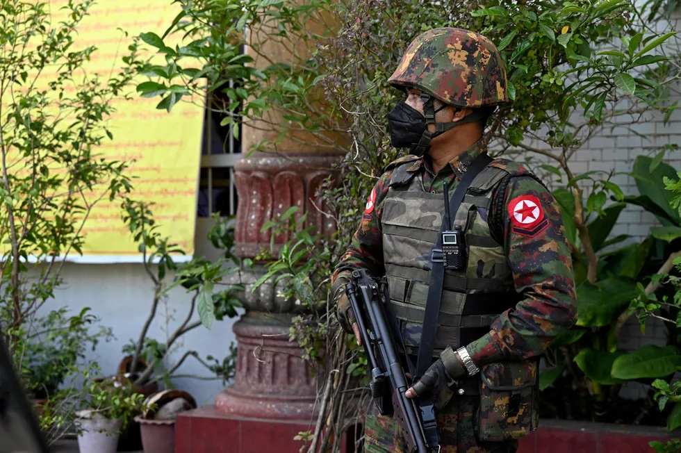Coup: a soldier stands at a temple in Yangon this week after Myanmar's generals took conntrol of the government