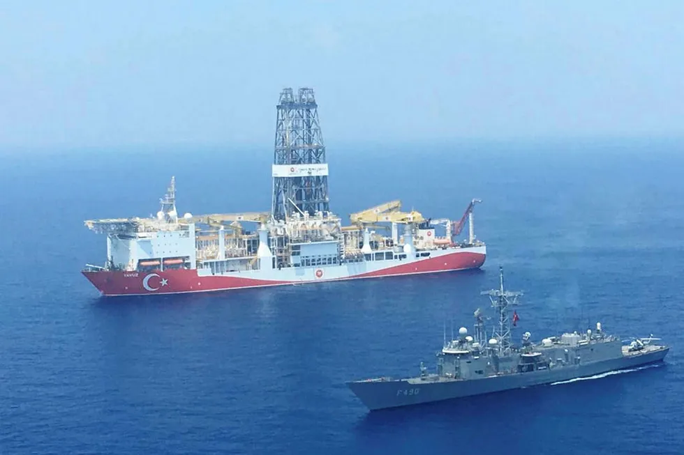 Tense: a Turkish Navy warship patrols next to a Turkish Petroleum drillship off Cyprus