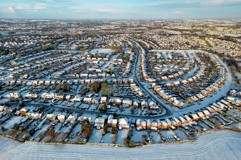 An aerial view of a British town covered in snow.