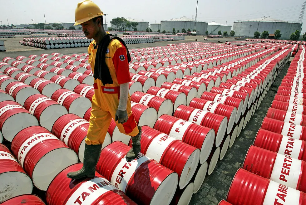 Drum beat: a Pertamina employee walks on the top of drums at an oil storage depot in Jakarta