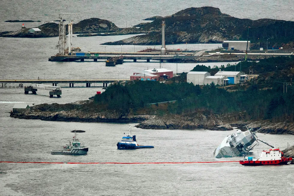 Den norske fregatten "KNM Helge Ingstad" ligger med slagside nær land etter at den kolliderte med tankskipet "Sola TS" natt til torsdag. Deler av Stureterminalen i bakgrunnen.
