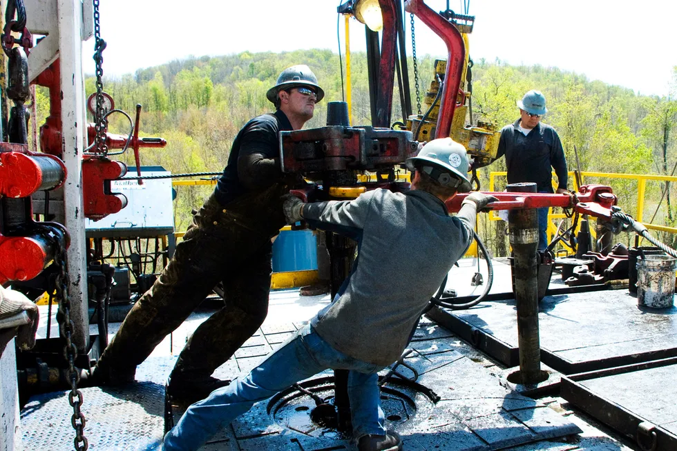 Activity: In this April 23, 2010, file photo, workers move a section of well casing into place at a Chesapeake Energy natural gas well site near Burlington, Pa.