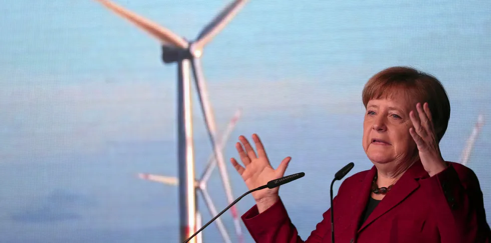 Angela Merkel, Germany's chancellor, gestures while delivering a speech at the inauguration ceremony of the Arkona wind park.