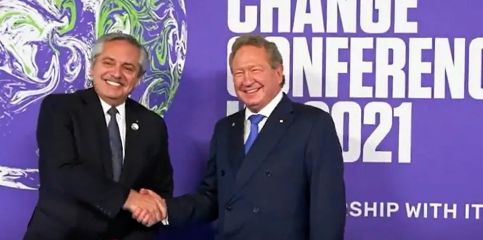 Argentine President Alberto Fernandez, left, shakes hands with Andrew Forrest at COP26 in Glasgow.