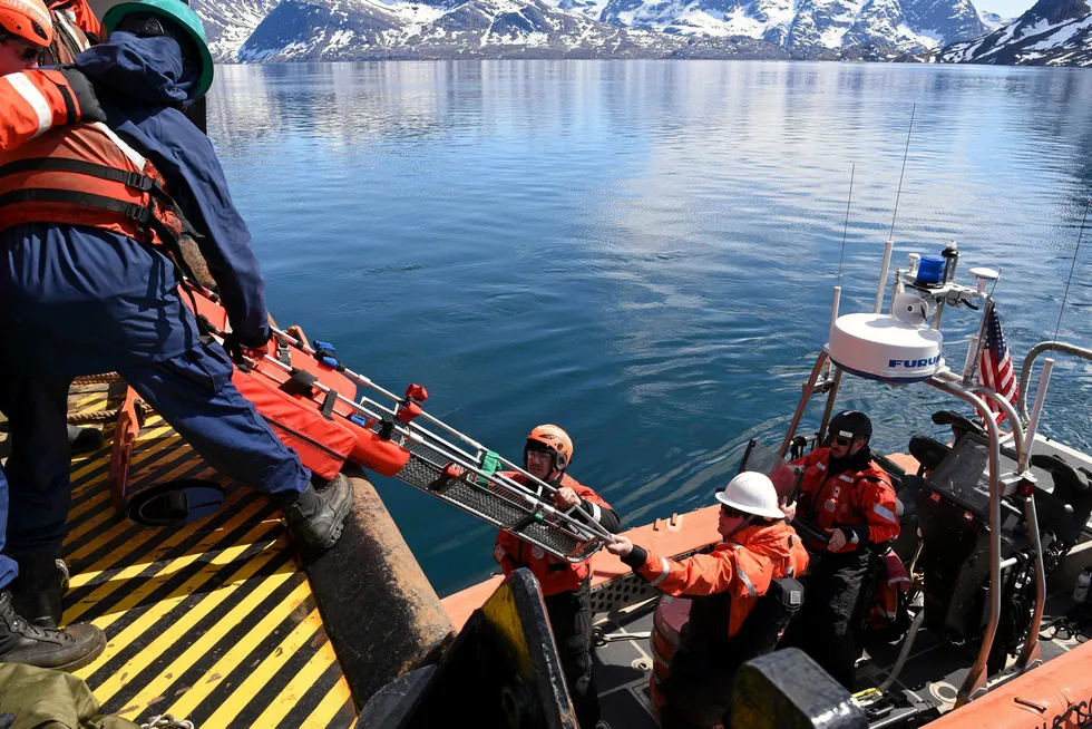 Training: Crew members from the USCGC Oak pictured during a medical drill conducted with Danish navy ship Ejnar Mikkelsen in the Hamborgersund fjords off Greenland