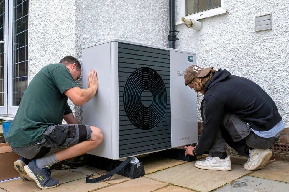 An air-source heat pump being installed in southern England.