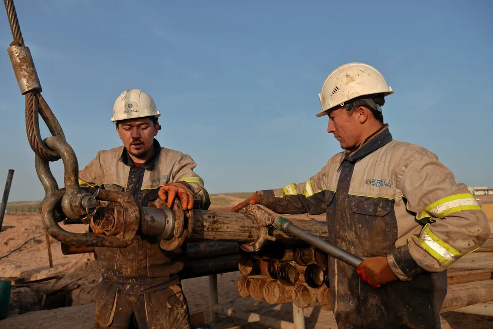 Advances: workers preparing a drill pipe at the Yangi Uzbekistan unconventional oilfield.