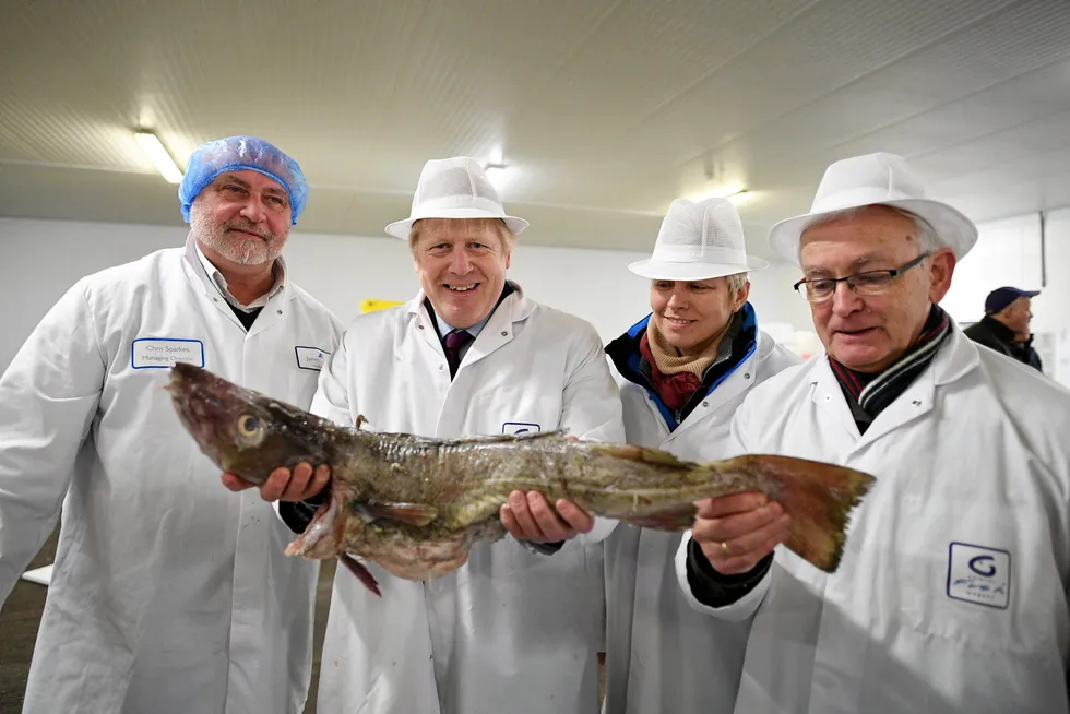 UK Prime Minister Boris Johnson pictured at Grimsby Fish Market during the optimistic days of 2019. UK seafood exporters are hurting following his Brexit trade deal, with some ceasing to trade completely.