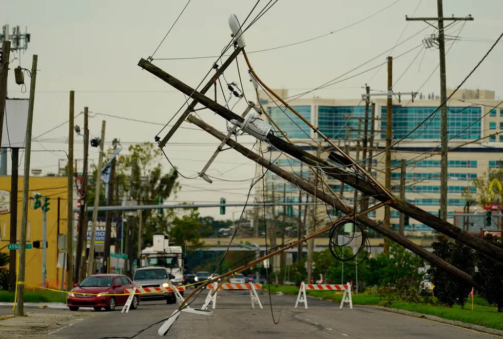 Devastation: Vehicles are diverted around utility poles damaged by the effects of Hurricane Ida in New Orleans