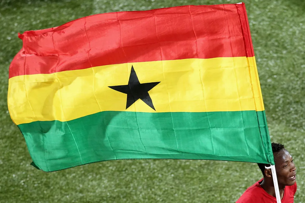 New plan: a Ghanian footballer carries his country’s flag