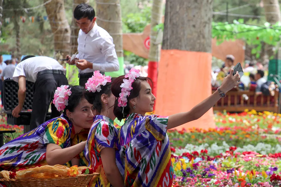 Nature call: People pose for a selfie during a traditional May flower festival in the city of Namangan in Uzbekistan