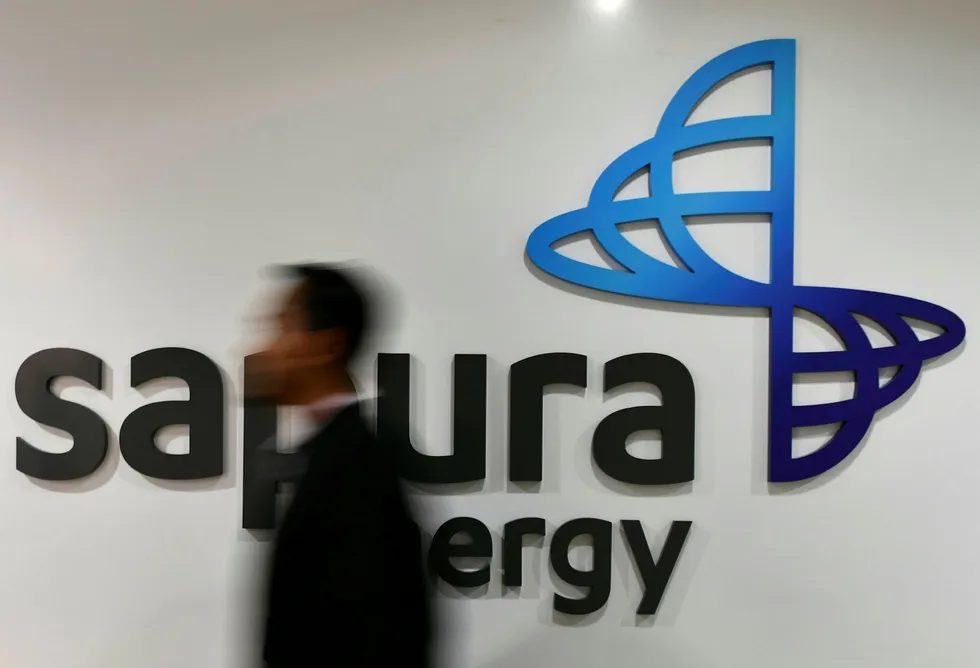 Orders: an employee walks past Sapura Energy's logo at its headquarters in Kuala Lumpur