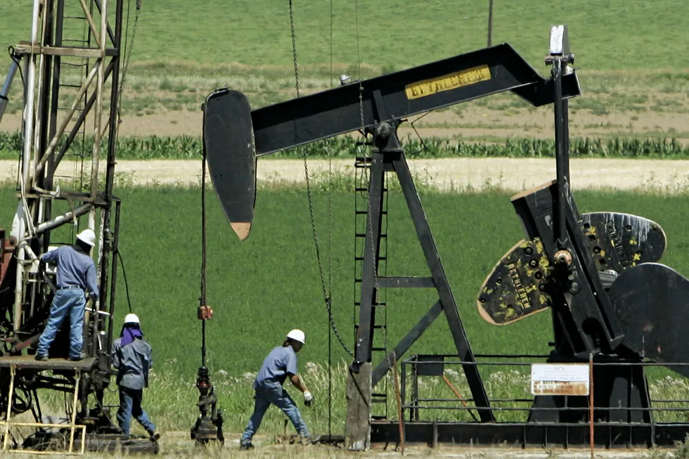 On site: workers install an oil well near Fort Lupton, Colorado