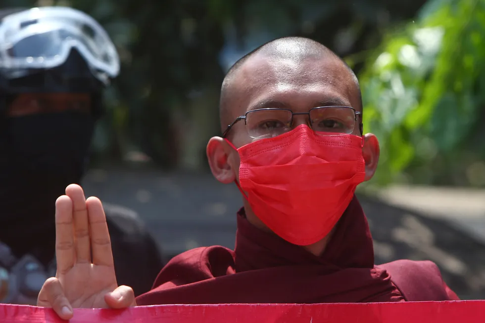 Demonstration: a monk in Mandalay, Myanmar displays a three-finger symbol of resistance during an earlier protest against the military coup.