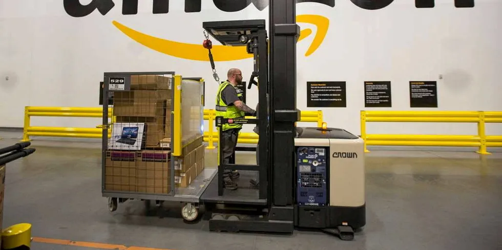 A worker drives a hydrogen-powered forklift fitted with a Plug Power fuel cell at Amazon's North Las Vegas fulfillment centre.