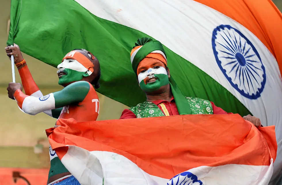 Indian supporters wave the national flag.